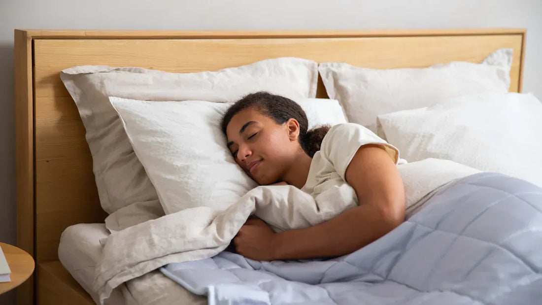Woman sleeping peacefully in bed demonstrating the impact of bedroom lighting on sleep and mood.