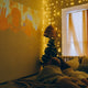 cozy kid's room with best lighting for kid's room 2025 featuring fairy lights and a movie projected on the wall