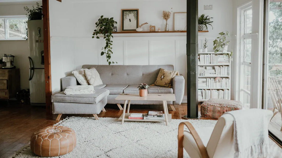 cozy modern spaces with Nordic light featuring a stylish gray couch and plants in a warm living room.