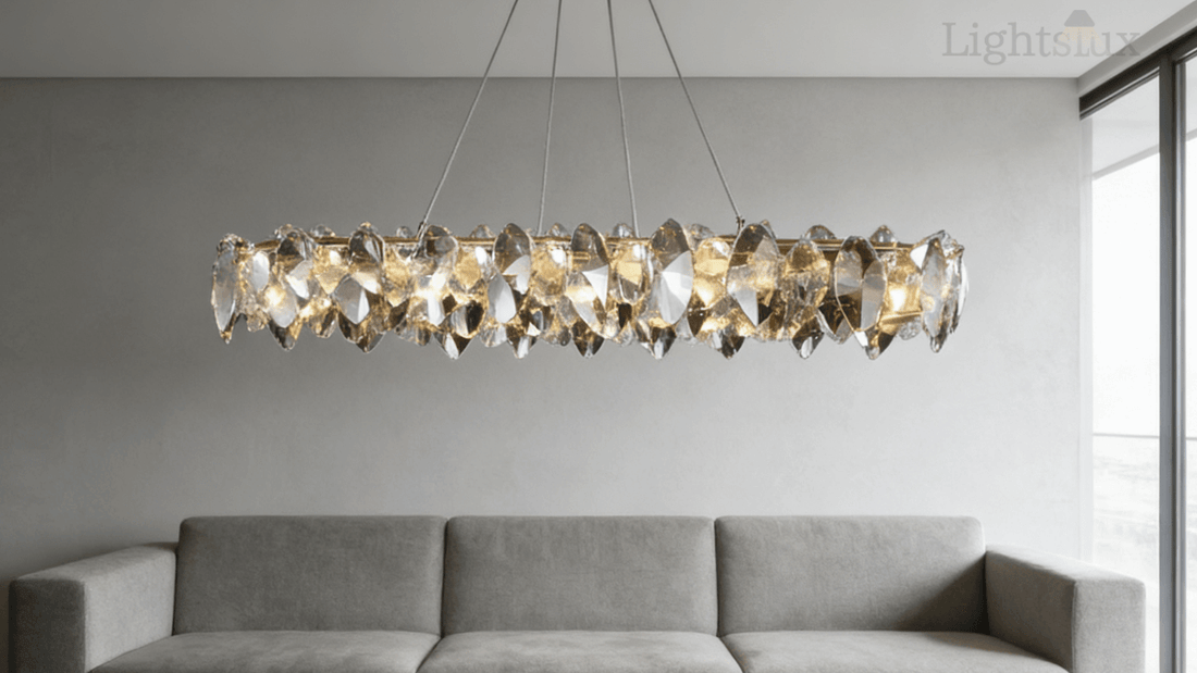 Stunning crystal chandelier above a modern gray sofa in an elegant living room, showcasing styles in the buyer's guide to crystal chandeliers.