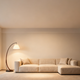 A cozy living room featuring modern lighting design aesthetics with a stylish arched floor lamp and a plush sofa.