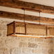 Farmhouse pendant lights hanging over a rustic kitchen, showcasing natural textures and warm tones.