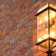 Outdoor wall lamps 2025 featuring a stylish glass design mounted on a brick wall for modern homes.