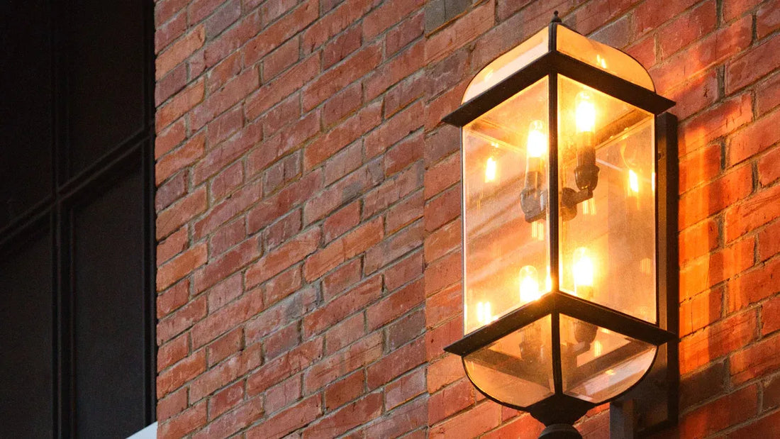 Outdoor wall lamps 2025 featuring a stylish glass design mounted on a brick wall for modern homes.