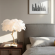feather table lamp mood lighting beside a bed, creating a cozy and inviting atmosphere in a modern bedroom.