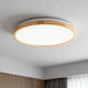Modern bedroom ceiling lights featuring a stylish round fixture with a wooden frame.